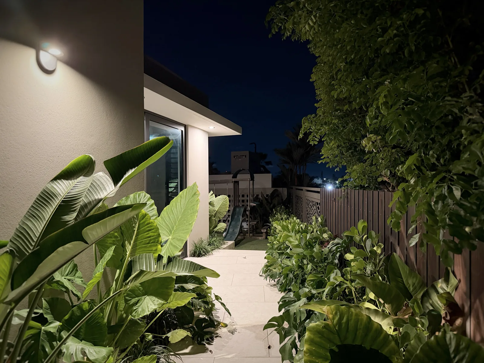 Paseo Real Addition — side garden path at night